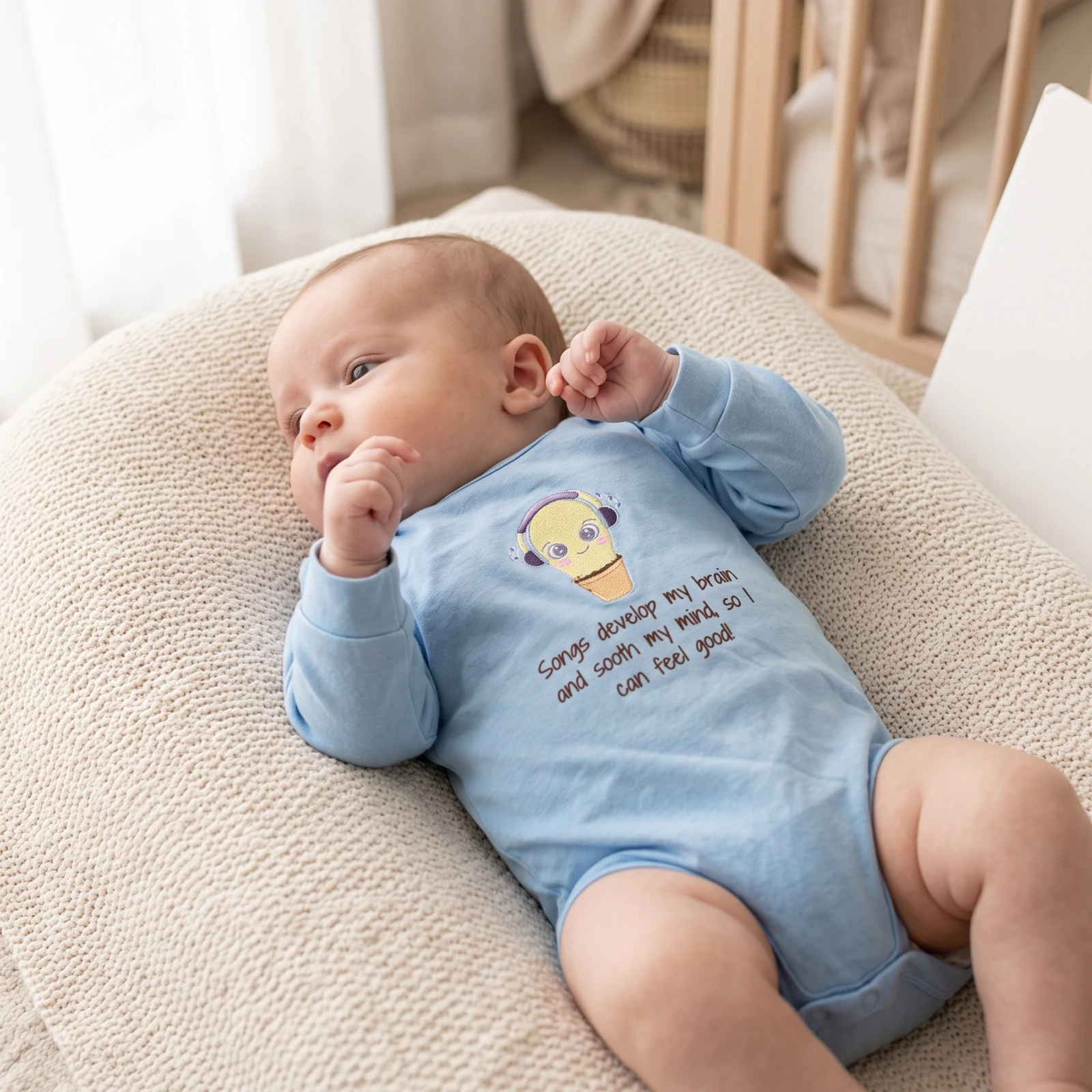 A baby lying in a crib wearing the sky blue onesie